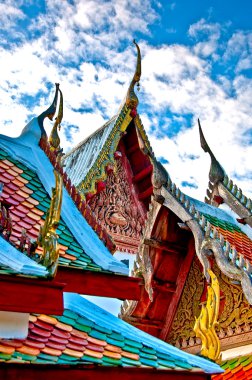 The Beautiful roof of temple on blue sky background clipart