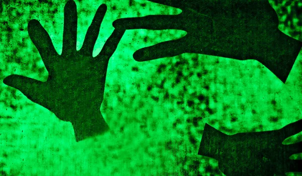 stock image The Shadow of black hand on green background