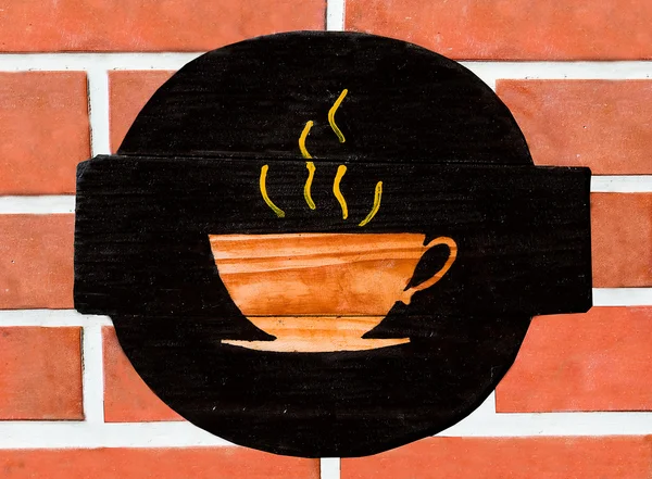 El signo de una taza de café en el fondo de la pared —  Fotos de Stock