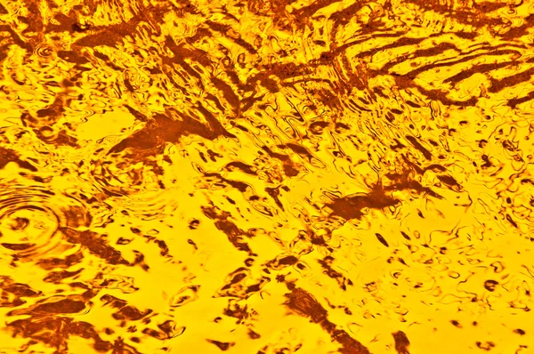 Textura žluté kalužemi vody — Stock fotografie