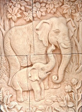 The Carving of sandstone with Mom elephant and baby elephant clipart