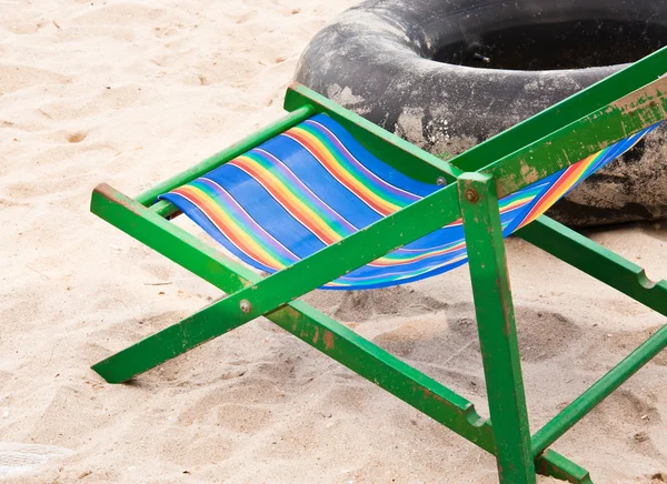 Folding chair and tire wheel. — Stock Photo, Image