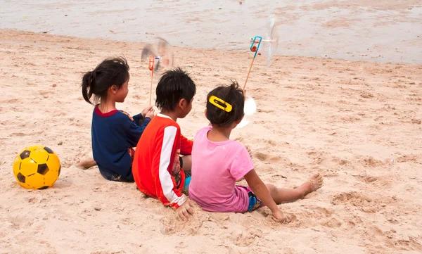 stock image Three children living on the beach.