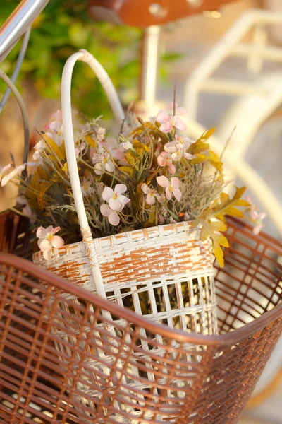 Artificial flower in bicycle basket — Stock Photo, Image
