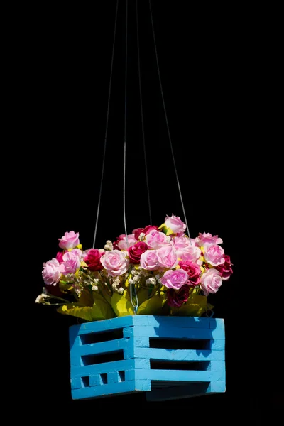 Artificial flowers in wood basket — Stock Photo, Image