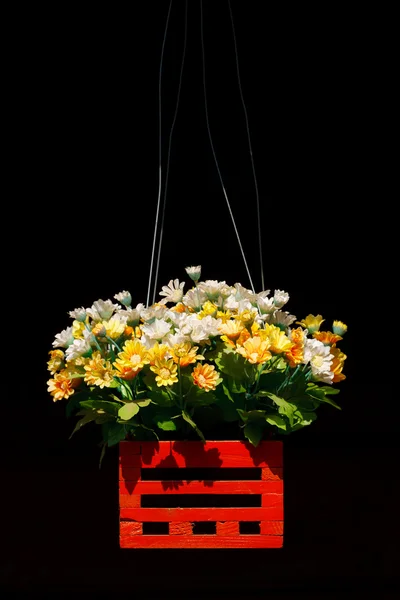 Artificial flowers in wood basket — Stock Photo, Image