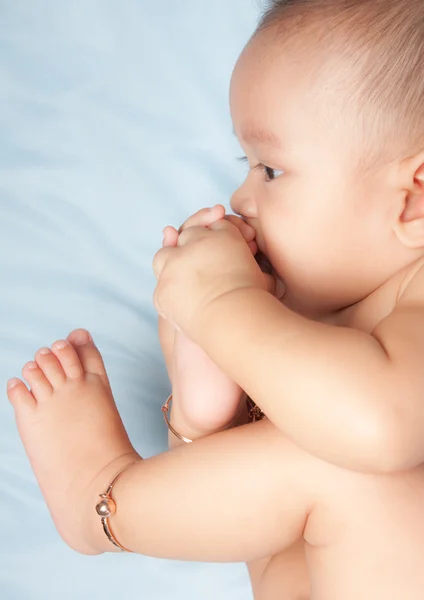 Baby boy playing with his foot — Stock Photo, Image