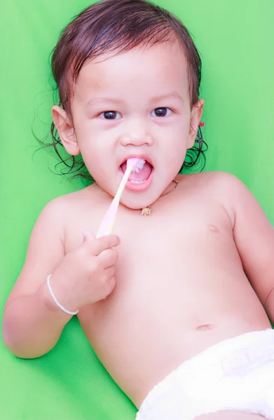 Asian baby and toothbrush — Stock Photo, Image