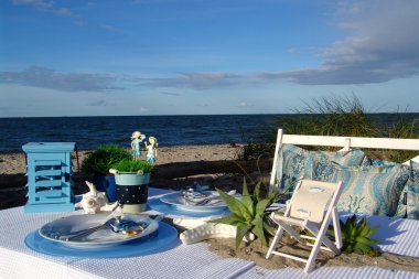 Table decoration on the beach. Sea air & adventure. clipart