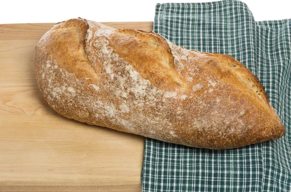 Baguette loaf on cutting board — Stock Photo, Image