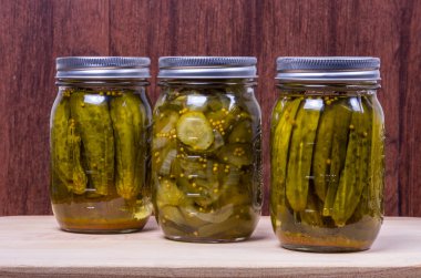 Three jars of pickled cucumbers clipart