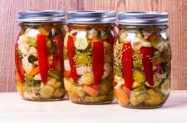Three jars of preserved mixed vegetables clipart