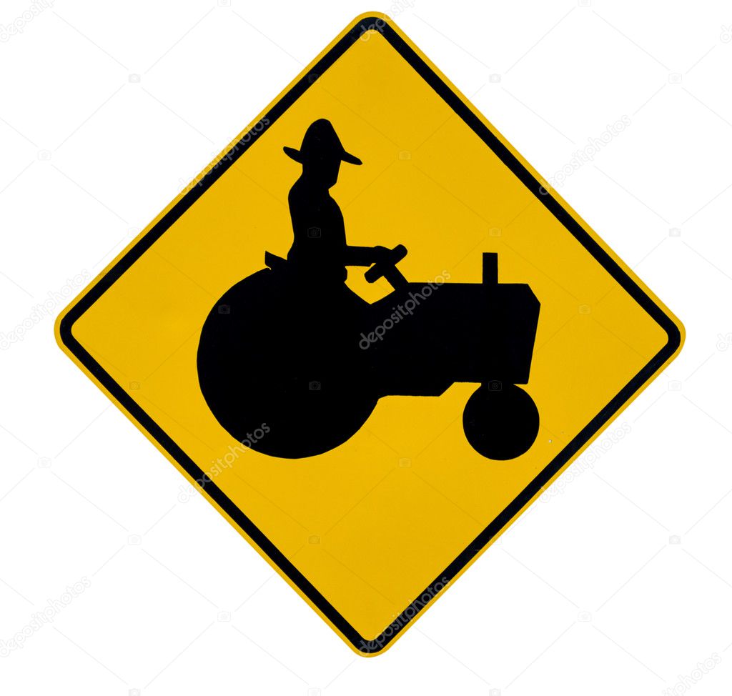 Tractor crossing yellow traffic warning sign