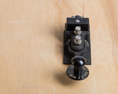 Antique telegraph key on a desk clipart