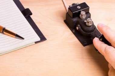 Telegraph key and notebook