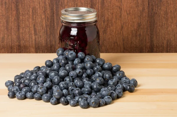 Fresh blueberries on wooden table with jam — Stock Photo, Image