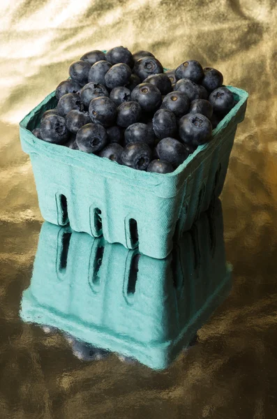 Blueberries on gold surface — Stock Photo, Image