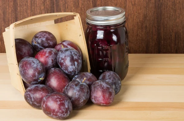 Prune plums with jar of jam — Stock Photo, Image