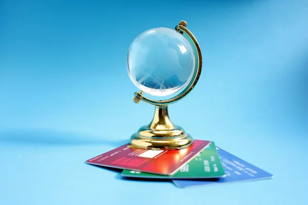 Glass globe with credit cards — Stock Photo, Image