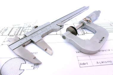 Caliper and Micrometer on blueprint horizontal close up. clipart