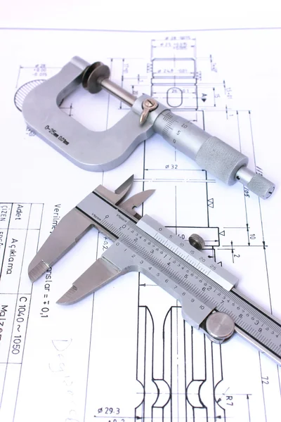 Micrometer and caliper on blueprint vertical — Stock Photo, Image