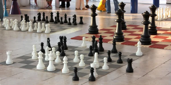 Schaakstukken in verschillende grootte op een schaakborden — Stockfoto