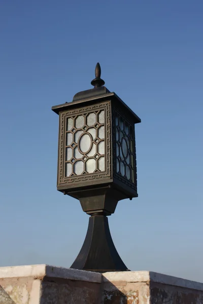 Old city lamp isolated on blue sky vertical — Stock Photo, Image