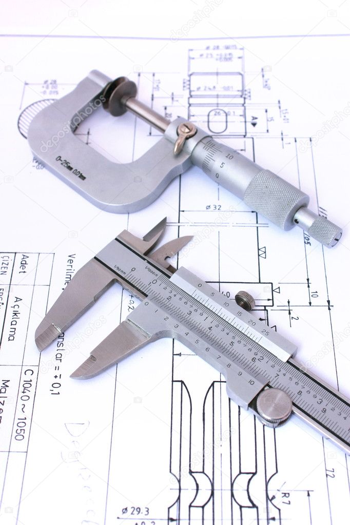 Micrometer and caliper on blueprint vertical