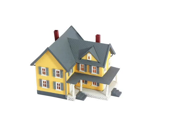 Gele miniatuur huis geïsoleerd op witte achtergrond — Stockfoto