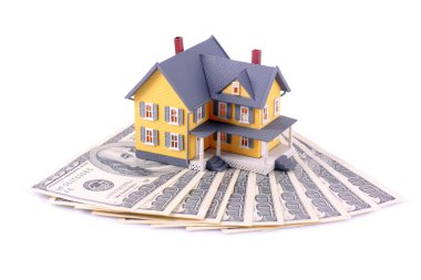 Miniature house over money isolated clipart