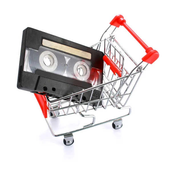 Compact casette in miniature shopping cart isolated on white — Stock Photo, Image