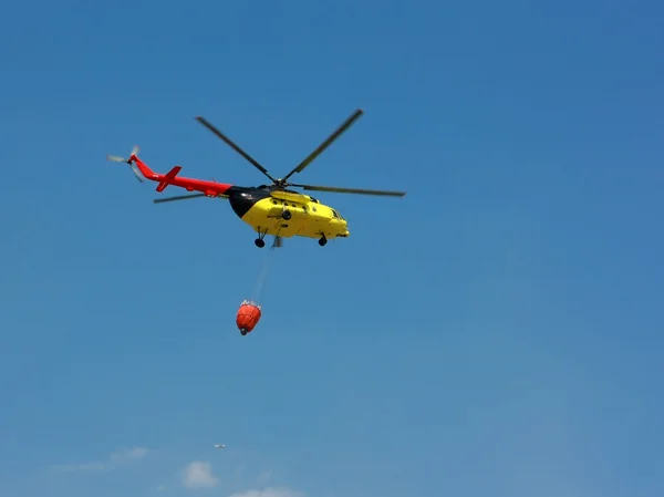 stock image Fire rescue helicopter with water bucket