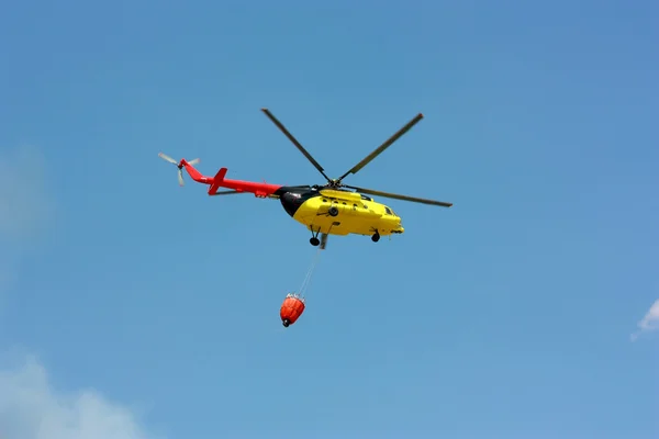 stock image Fire rescue helicopter with water bucket