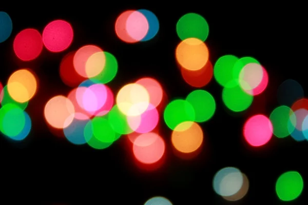 Luces de Navidad desenfocadas con fondo negro — Foto de Stock