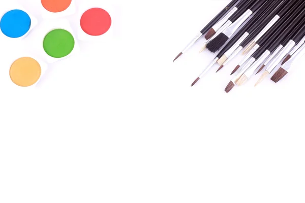 Different type of brushes and water color paints on white — Stock Photo, Image