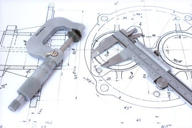 Micrometer and caliper on blueprint clipart