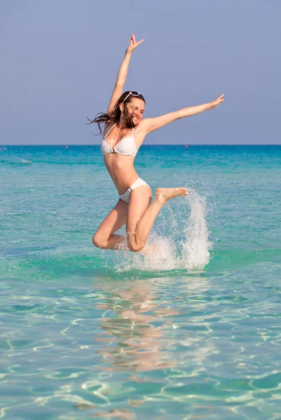 A woman is jumping in water