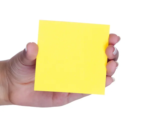 Mão feminina com um post-it amarelo — Fotografia de Stock