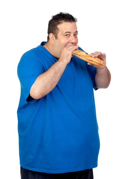 Homem gordo feliz comendo um pão grande — Fotografia de Stock