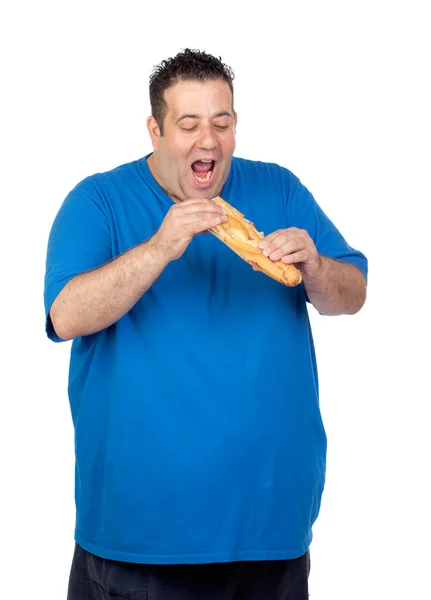 Lycklig fett man äter ett stort bröd — Stockfoto