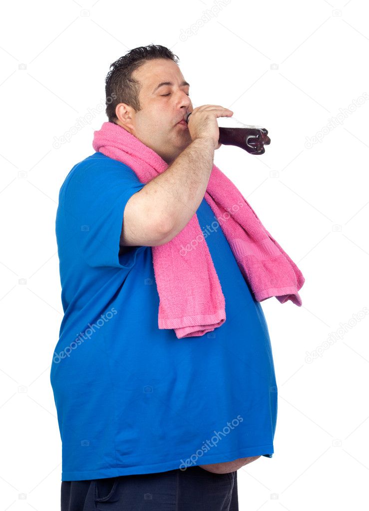 Fat man in the gym drinking cola