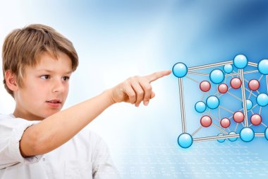 Young boy pointing at 3D molecules. clipart