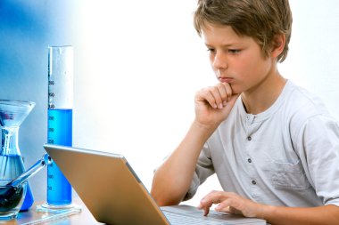 Young science student with laptop. clipart