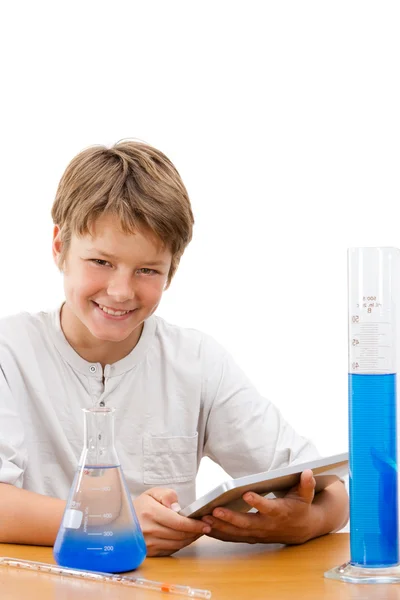 Young science student with tablet doing homework. — Stock Photo, Image