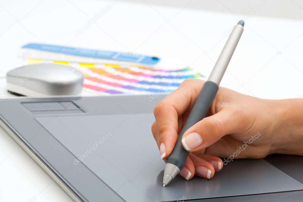 Female hand using pen on digital tablet.