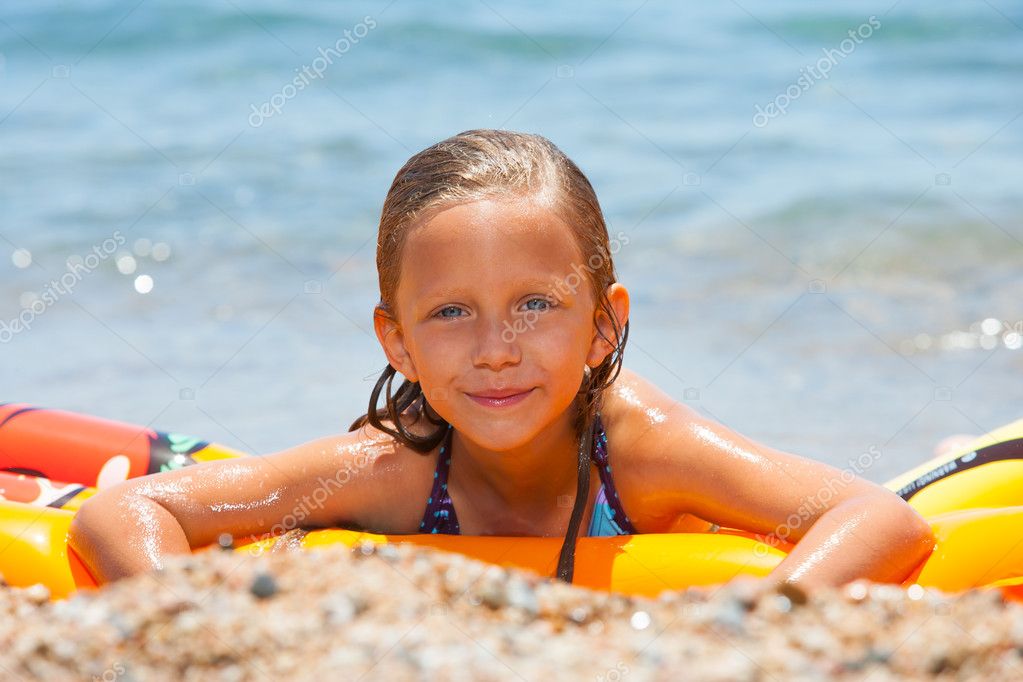 Girl having fun on air mattress. — Stock Photo © karelnoppe #11829185