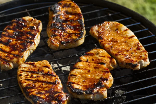 stock image T-bone steak cooking on an open flame grill