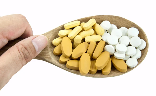 Le pillole su mestolo cucchiaio di legno . — Foto Stock