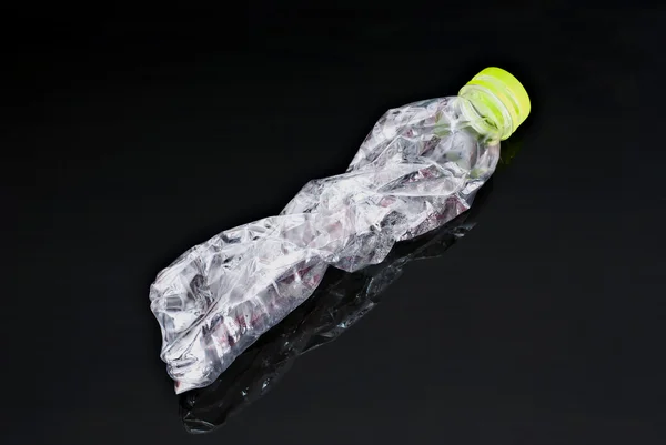 Close up of used plastic bottle on black background — Stock Photo, Image