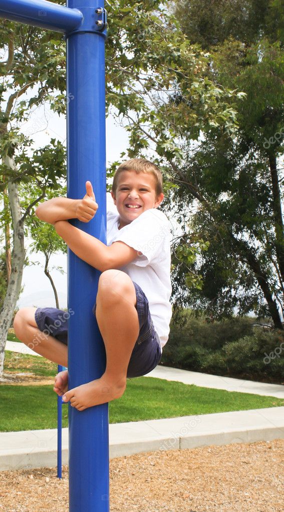 Boy on pole with thumbs up sign